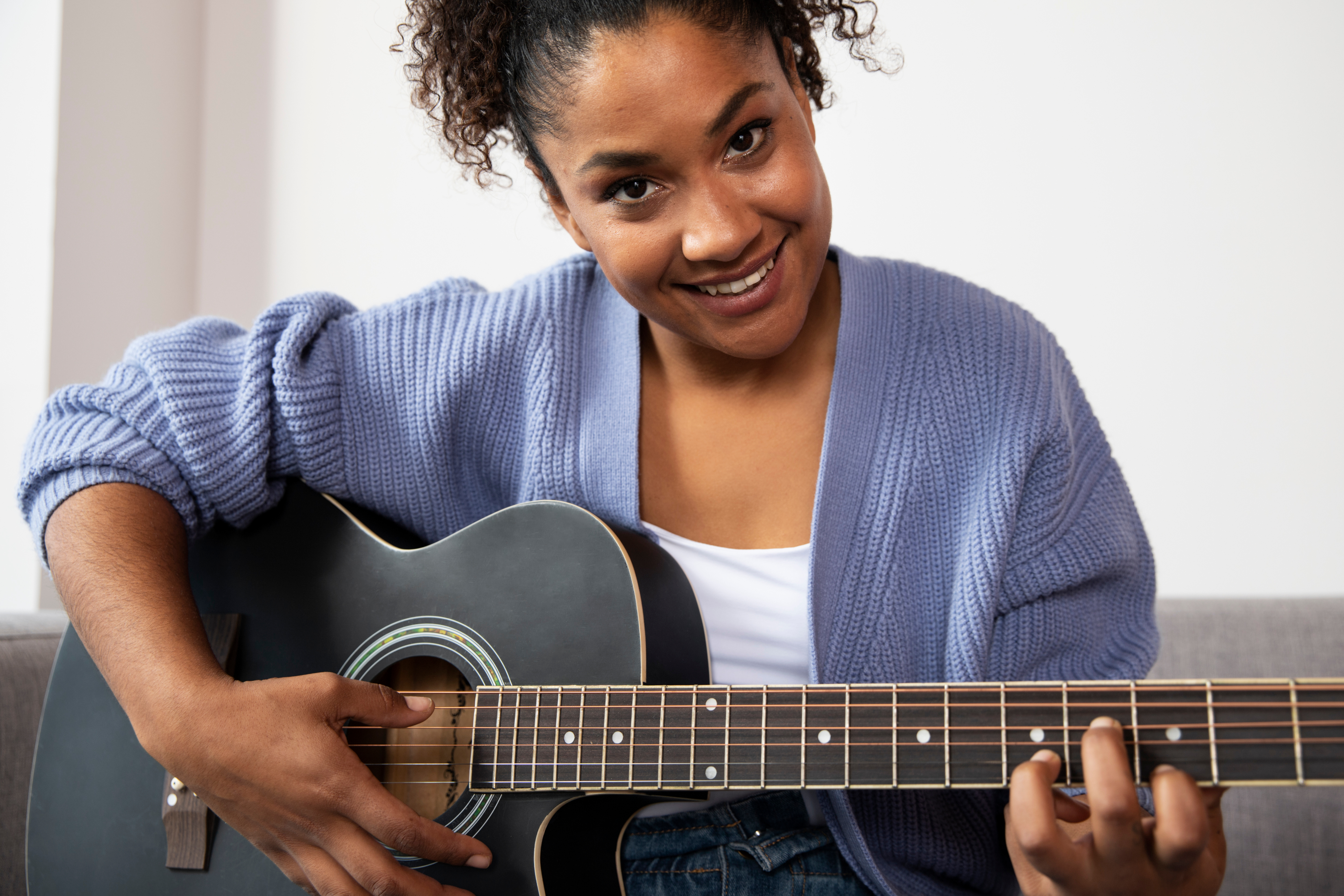 A woman playing guitar